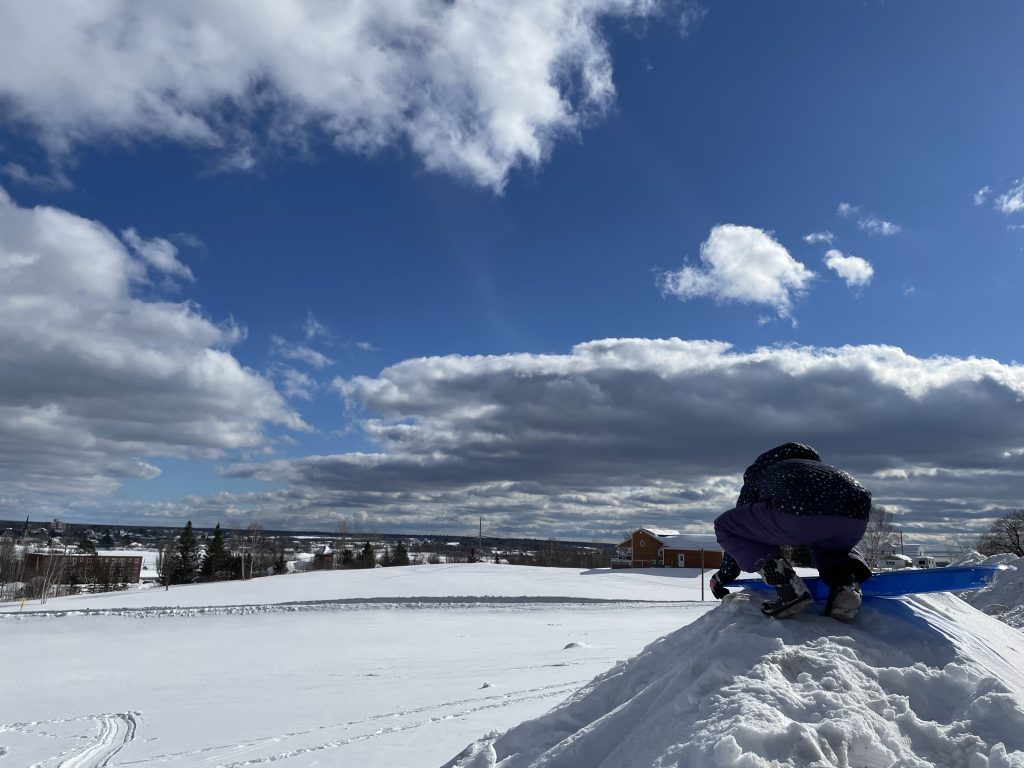 The moment before sliding down the hill.